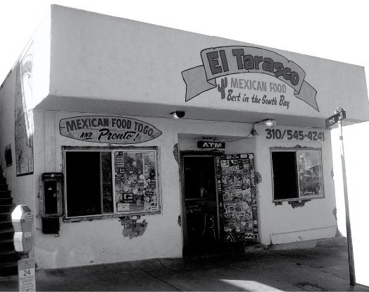 An early El Tarasco storefront with a “Mexican food to go and pronto!” sign