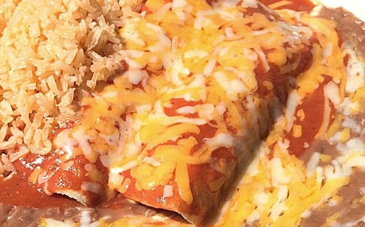 Two enchiladas in red sauce with melted cheese, rice and beans